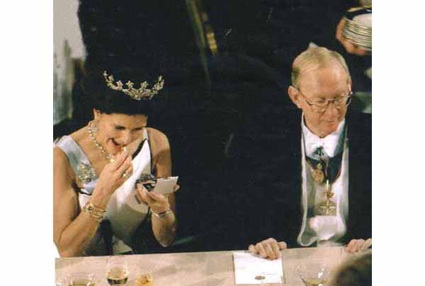 Queen Sylvia of Sweden adjusting her makeup during a banquet